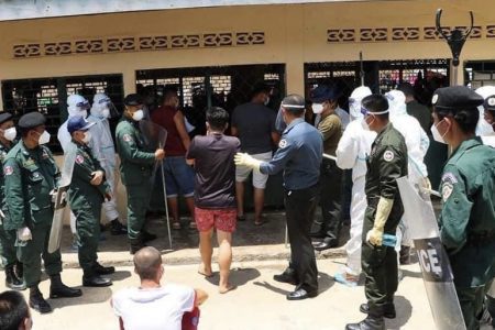 Police and military police are deployed at the Chivith Thmey Phnom Bak Center in Banteay Meanchey province to crack down on protesting patients demanding to be treated at home after having tested positive for COVID-19. Photos posted on Banteay Meanchey provincial administration's Facebook page on August 18, 2021.