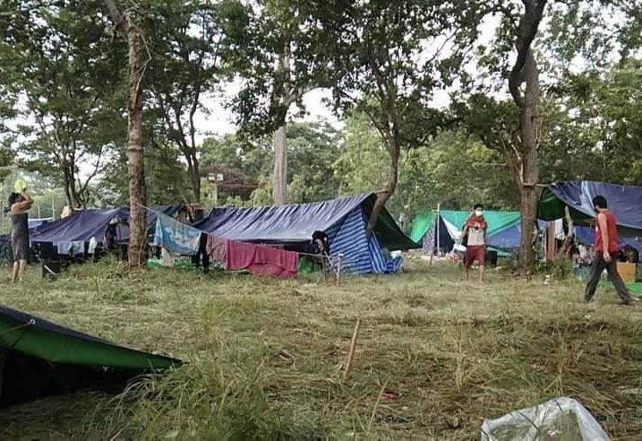 Returning migrant workers have built temporary shelters from tarps in the forest near the Thai-Cambodian border. Supplied