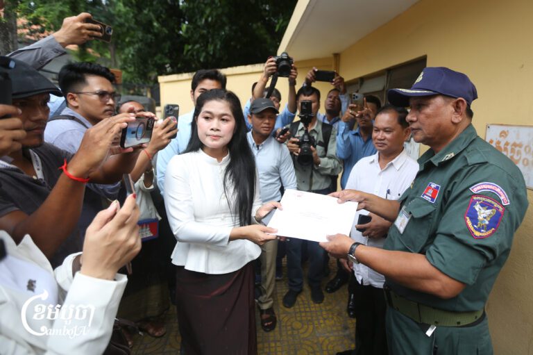 Nation Power Party members hand a letter to Royal Palace Protection Police Unit officers seeking a royal pardon for party adviser Rong Chhun. July 17, 2026. (CamboJA/Pring Samrang)