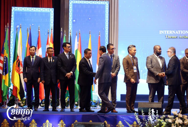 Senior delegates greet each other during the closing session of the International Conference on Combating Online Scams in Phnom Penh, Sept. 24, 2026. (CamboJA/Pring Samrang)